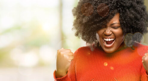 A woman pumping her fist, excited